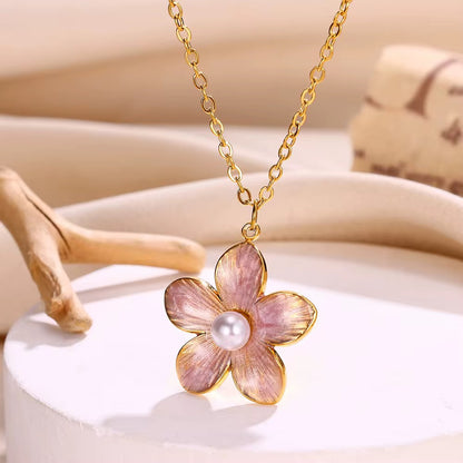 Floral pendant necklace with a pearl center on a neutral background
